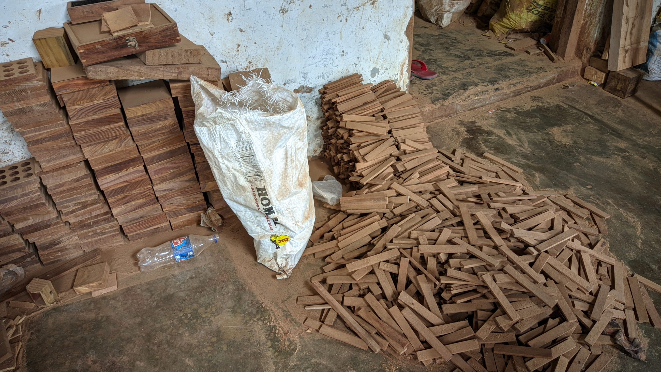 Raw wooden materials being prepared in a traditional Indian workshop